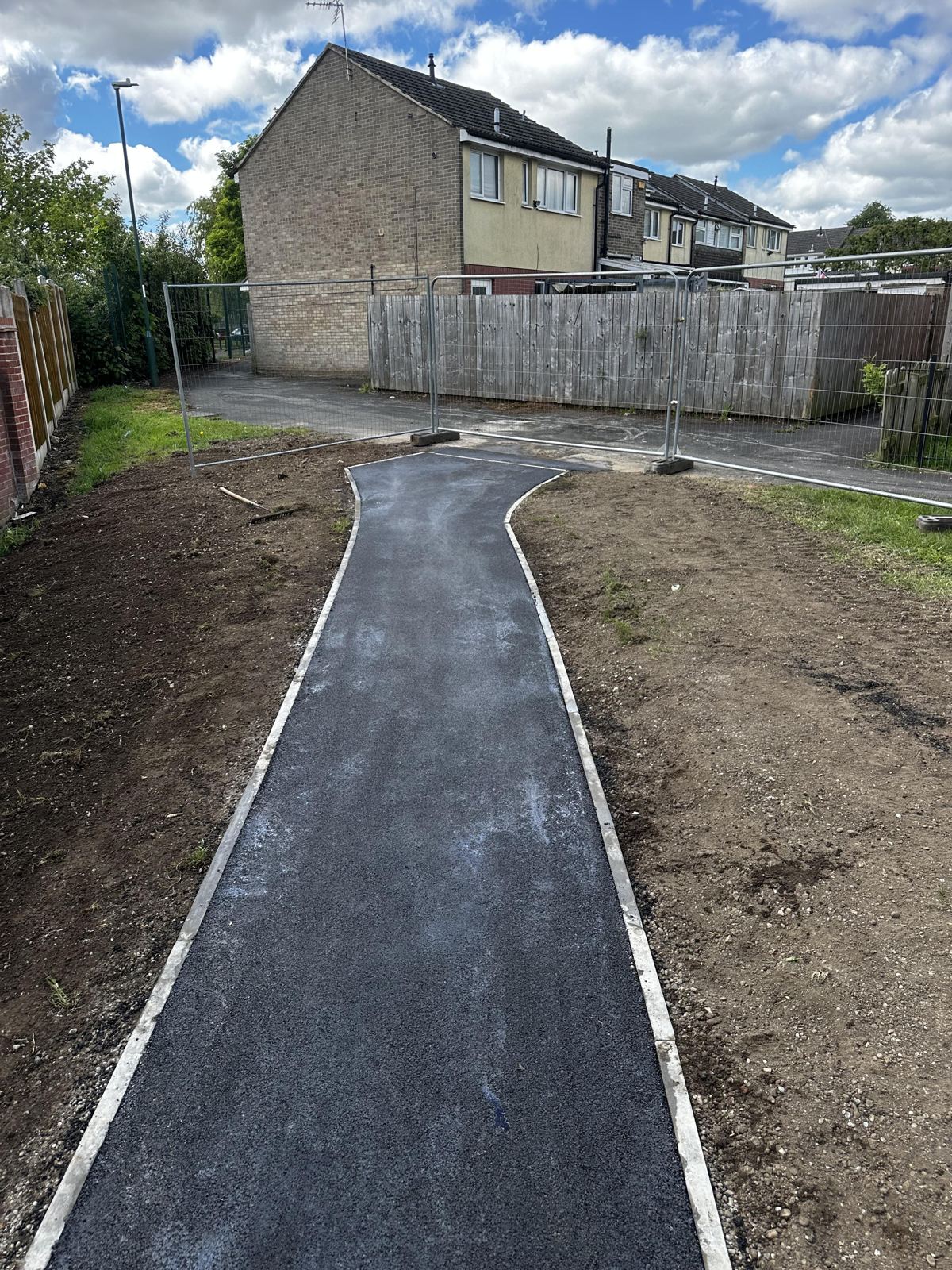 New curved tarmac footpath with kerb edging