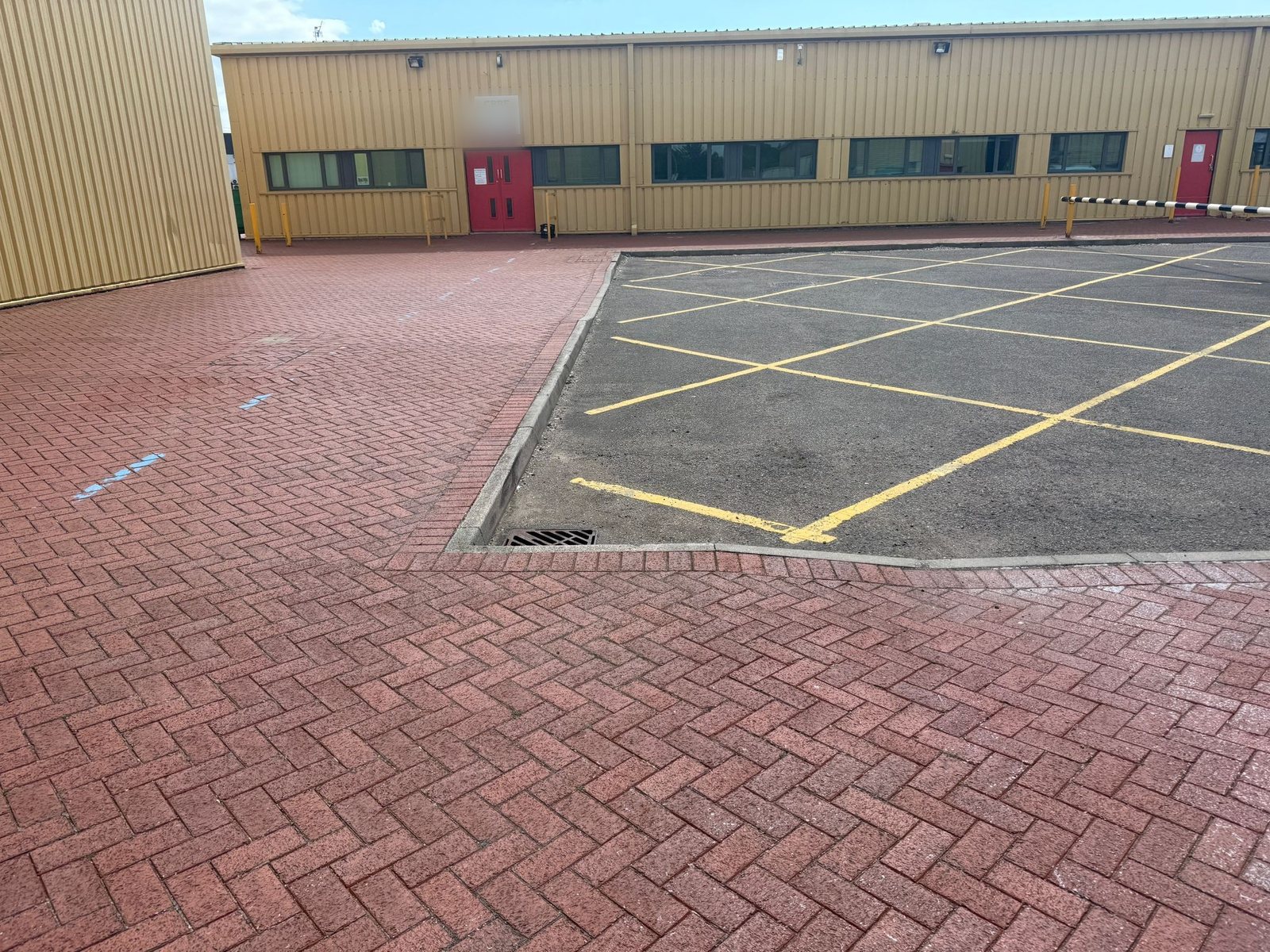 Herringbone block paving and newly lined car park at an industrial unit