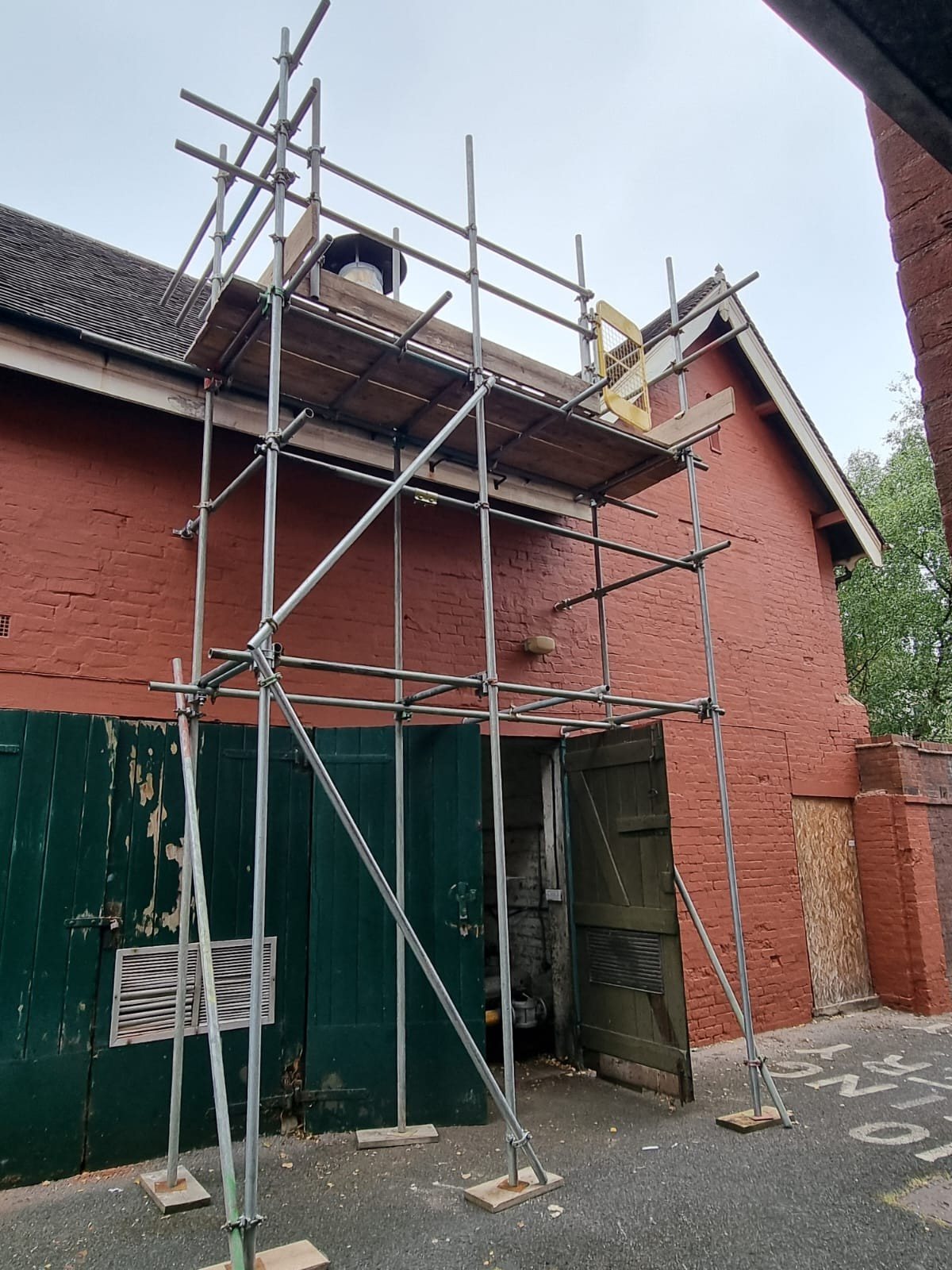 Access scaffold with ladder access erected to a brick gable
