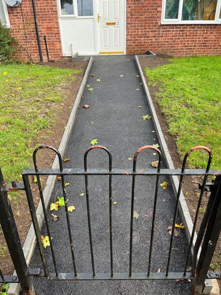 New tarmac path with gate to a ground-floor flat
