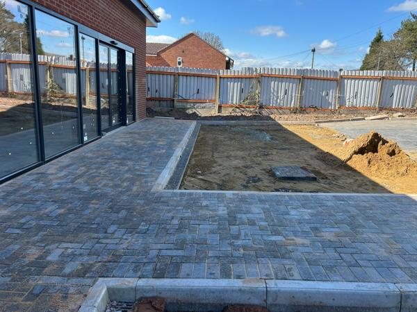 Block-paved surround and planting bed to a new building