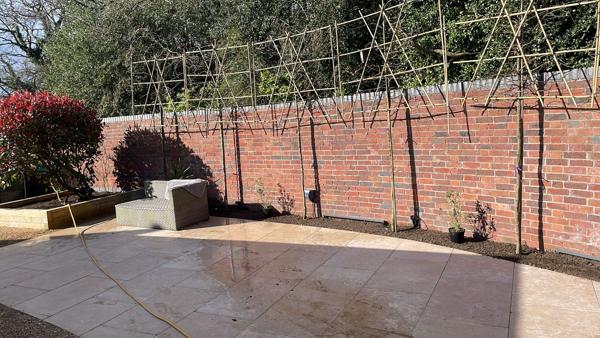 Patio and raised beds with new brick boundary wall