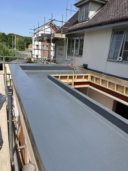 GRP fibreglass flat roof with roof lanterns on an extension