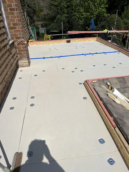 Flat roof insulation and membrane being installed