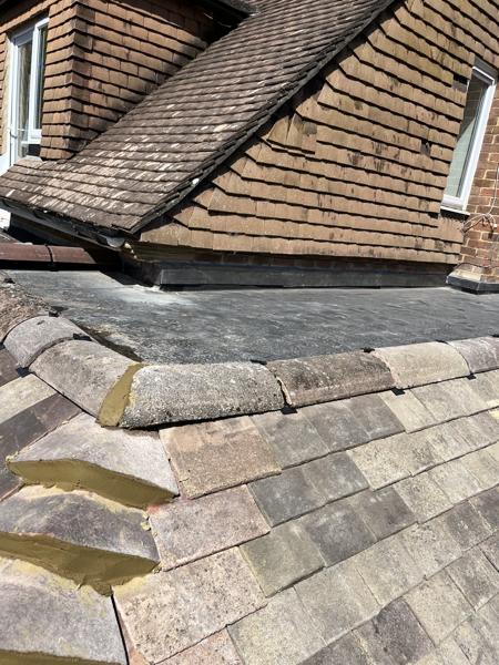 Plain clay tile roof and flat roof abutment